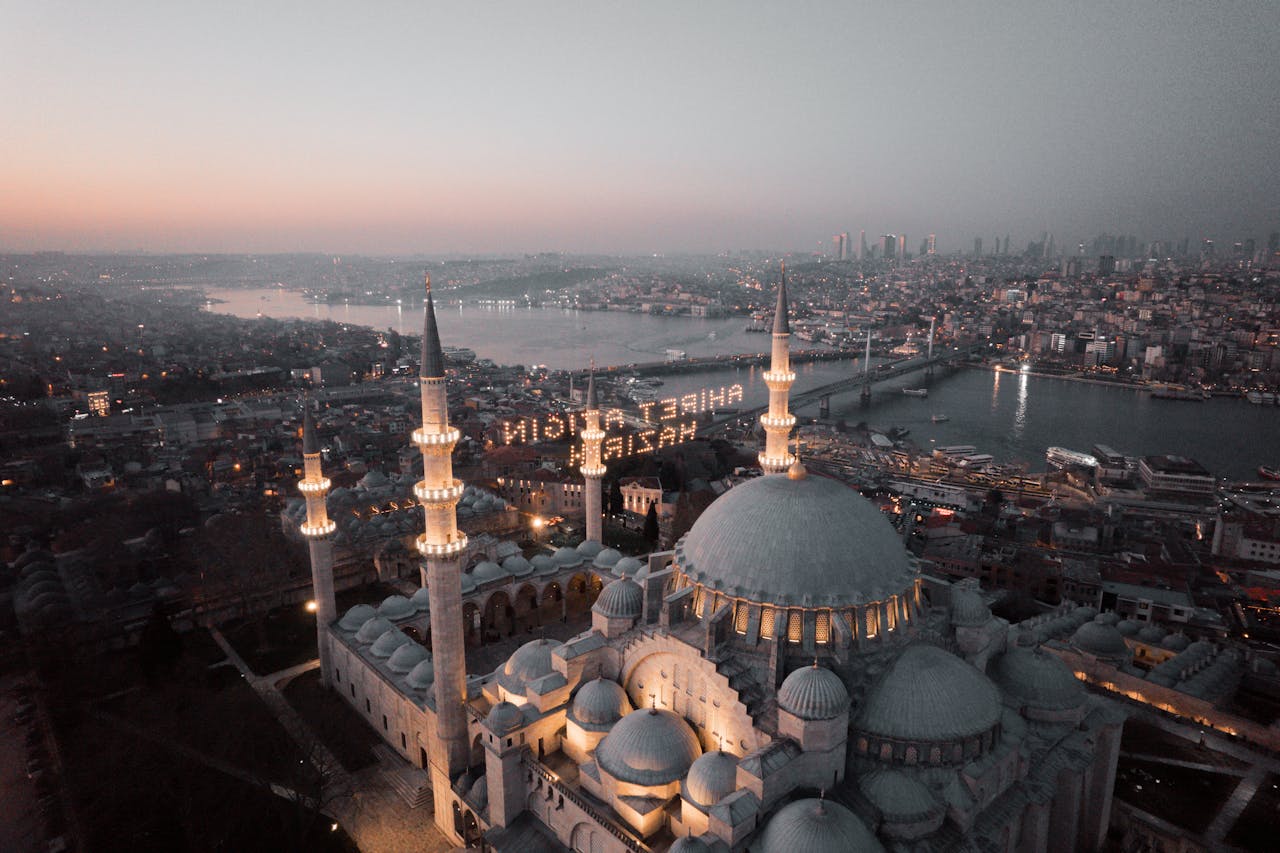 Stunning aerial view of Suleymaniye Mosque in Istanbul with cityscape at sunset.